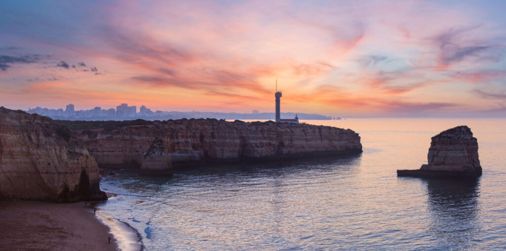 sea-coast-sunset-view-with-lighthouse-of-ponta-do-altar-west-view-over-praia-da-afurada-beach-ferragudo-lagoa-algarve-portugal-two-shots-stitch-panorama-fishermen-are-unrecognizable